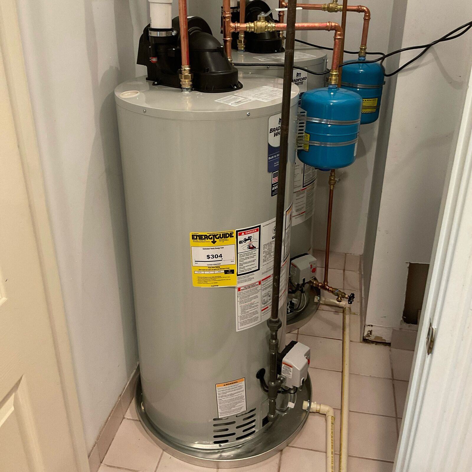 Storage-tank water heater with visible piping