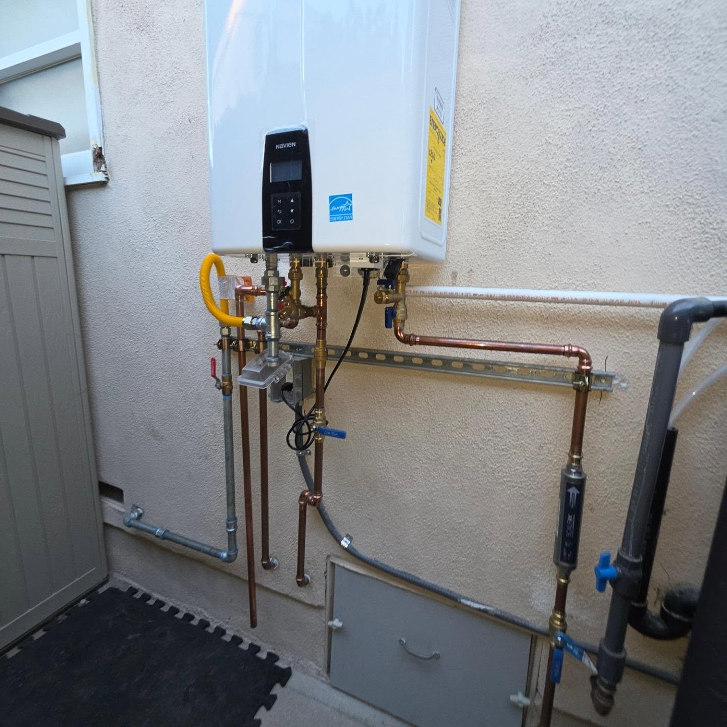 Gas and water connections at an exterior tankless water heater