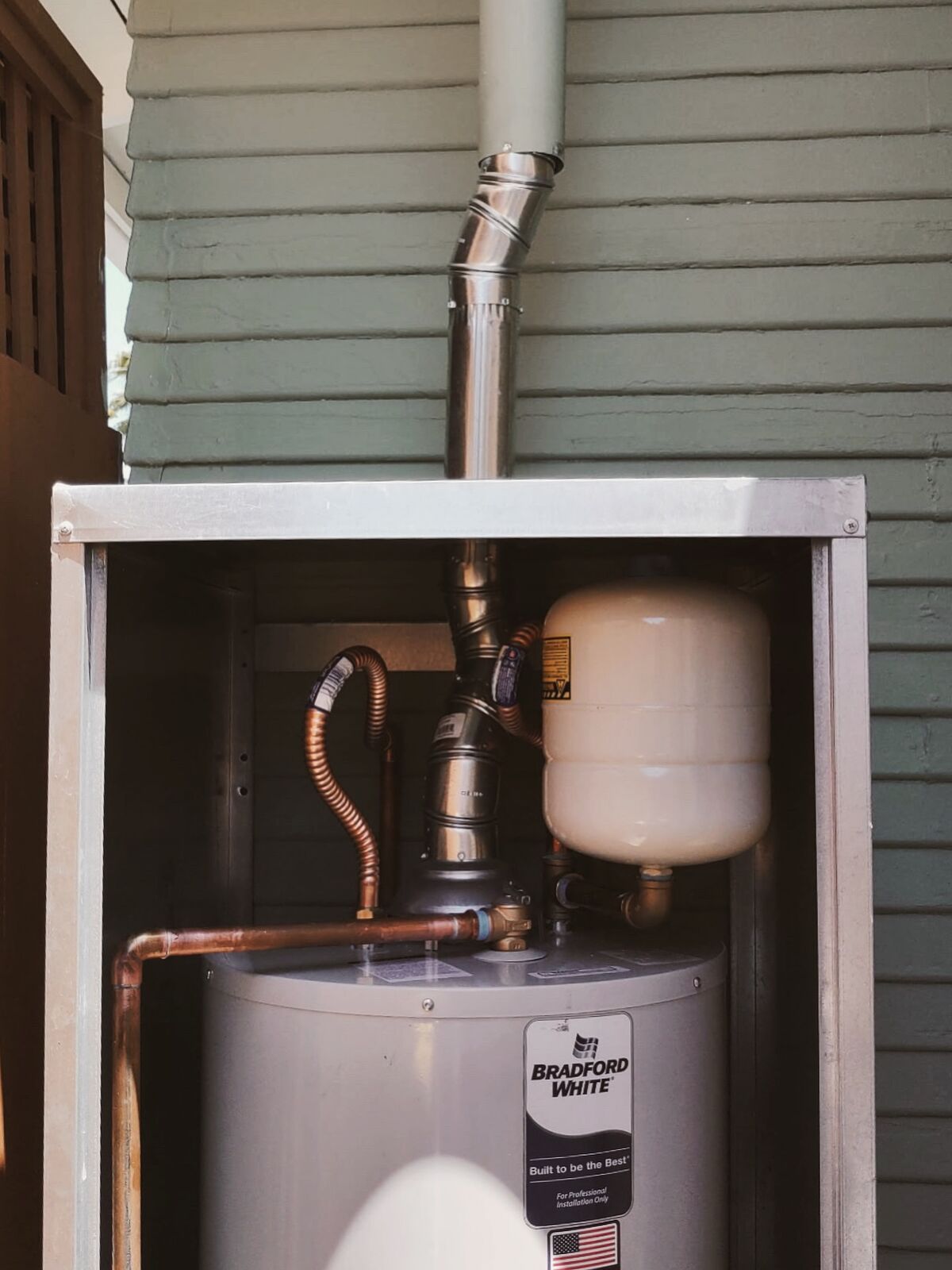 Copper connections and expansion tank in an exterior water heater cabinet