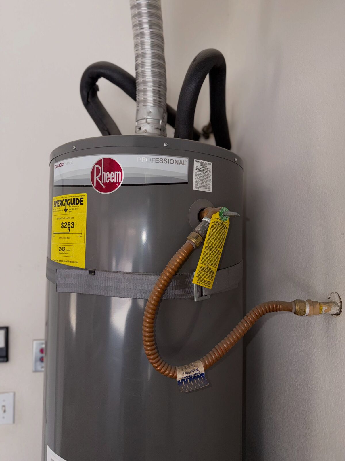 New Rheem gas water heater with water and gas connections